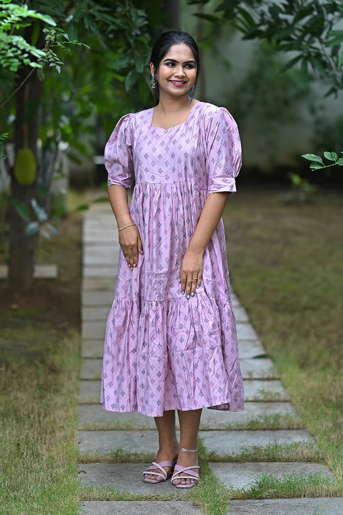 Side view showing A-line fit and tiered silhouette of light lilac floral midi kurti
